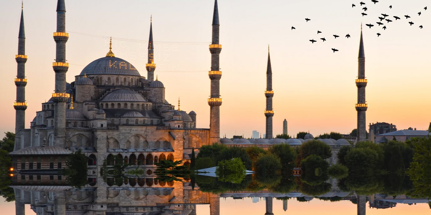 News sky outdoor reflection light mosque landmark traffic place of worship spire tourist attraction yellow building morning dome evening byzantine architecture City dusk historic site dawn metropolis cityscape tourism day