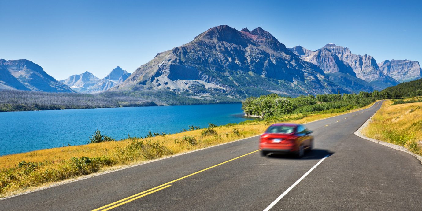 Road Trips Travel Tips mountain sky road outdoor grass mountainous landforms mountain range way scene car highway roadway road trip mountain pass vehicle alps infrastructure Lake controlled access highway fjord driving reservoir traveling highland