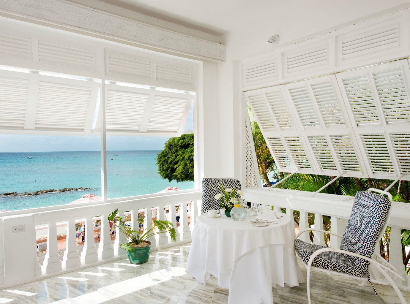 Balcony Beach Beachfront Country Elegant Island Lounge Nature Outdoors Scenic views Terrace Trip Ideas Waterfront window indoor room property interior design white estate home window covering real estate porch furniture