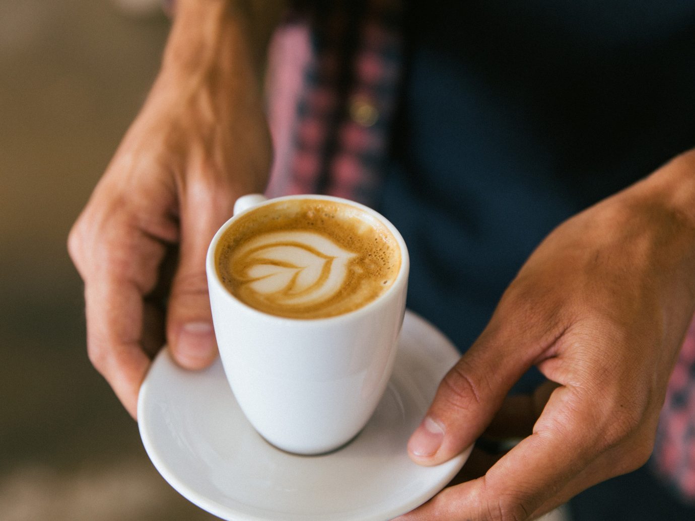 Jetsetter Guides cup coffee person Drink beverage indoor food latte caffeine espresso sense flavor breakfast coffee cup