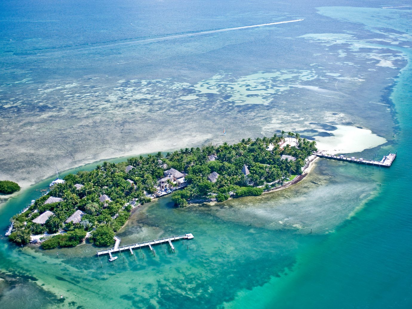 Beach Beachfront Hotels Island Outdoors Resort Romance Romantic Waterfront water water sport aerial photography outdoor archipelago geographical feature landform Sea Coast mountain caribbean Nature Ocean islet Sport reef atoll atmosphere of earth cape bay artificial island surfing bird's eye view vehicle wave terrain Lagoon