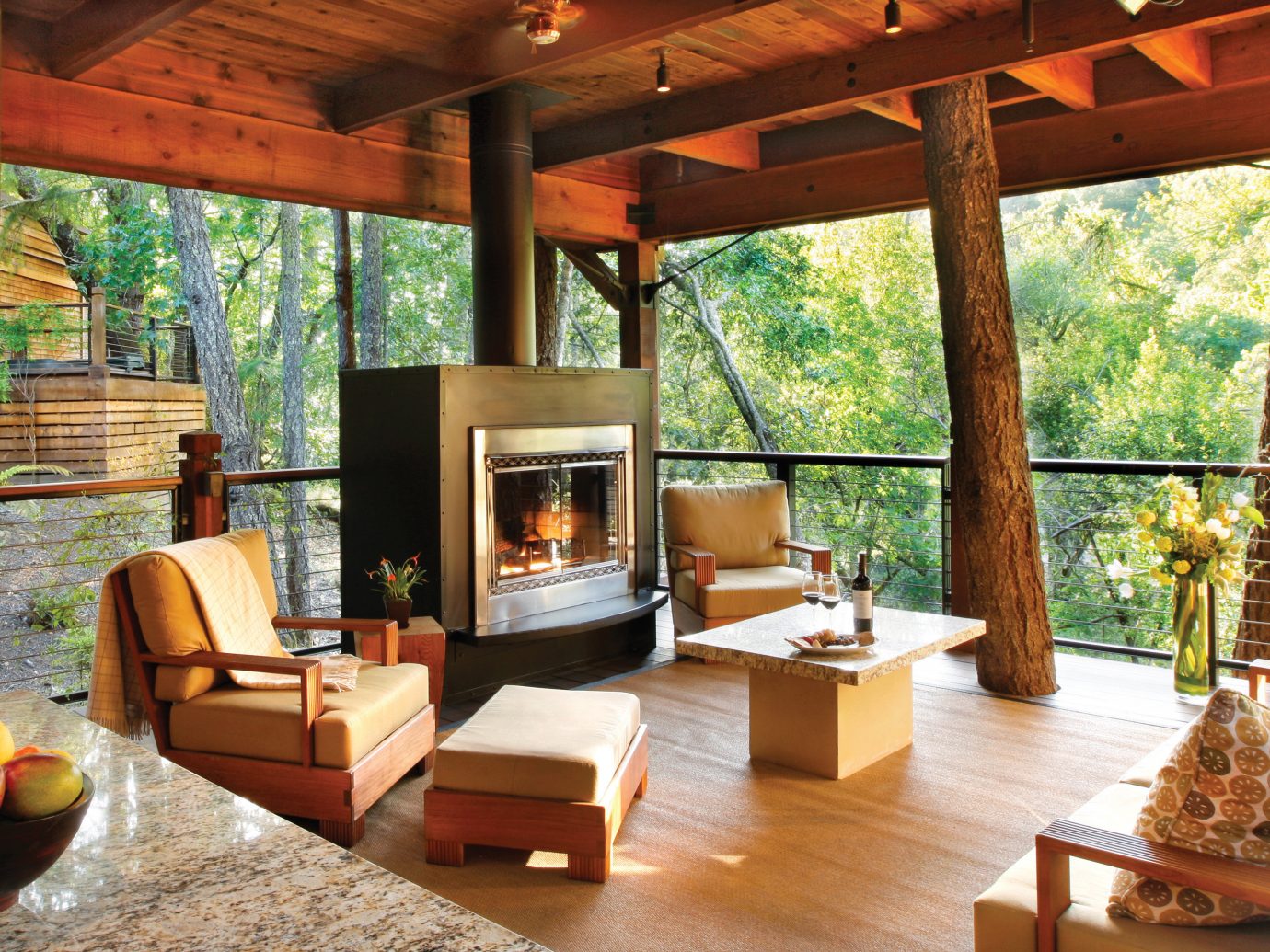Eco Fireplace Food + Drink Hotels Luxury Outdoors Ranch Romance Romantic Rustic Scenic views Trip Ideas Wellness table indoor Living room property window estate Resort wooden living room home Villa cottage interior design real estate hacienda eco hotel outdoor structure farmhouse porch log cabin wood furniture