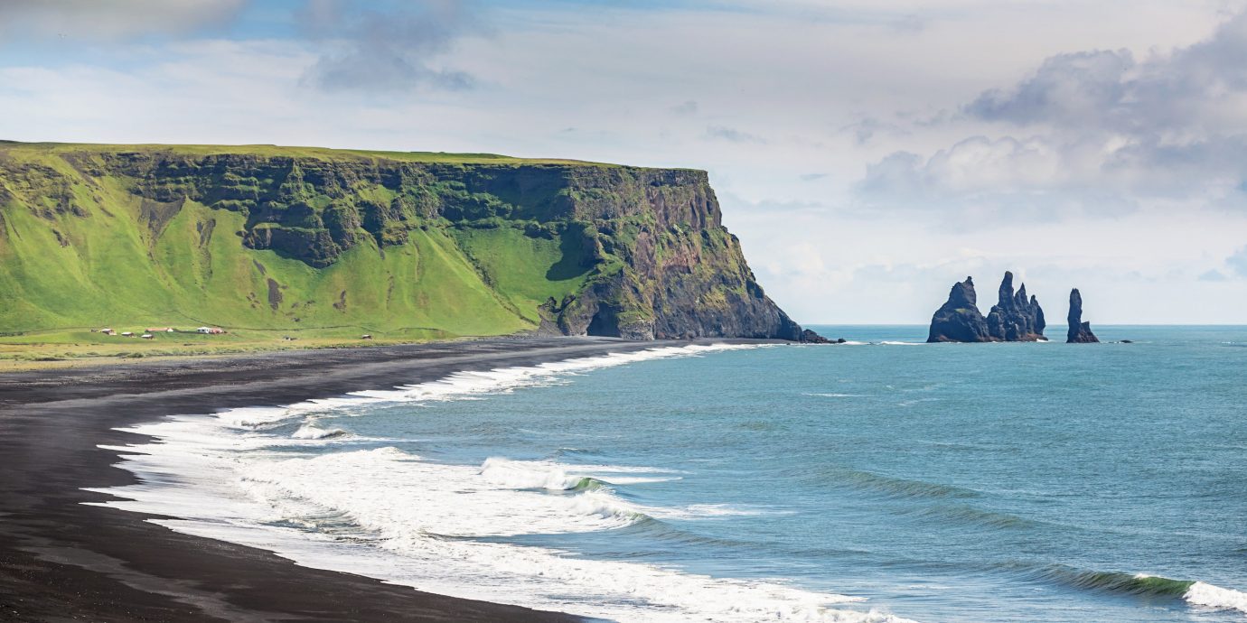 Iceland Outdoors + Adventure Road Trips outdoor sky water Nature Coast cliff Sea geographical feature mountain shore landform Ocean body of water wave wind wave vacation bay Beach terrain rock cape cove Island fjord islet material promontory day