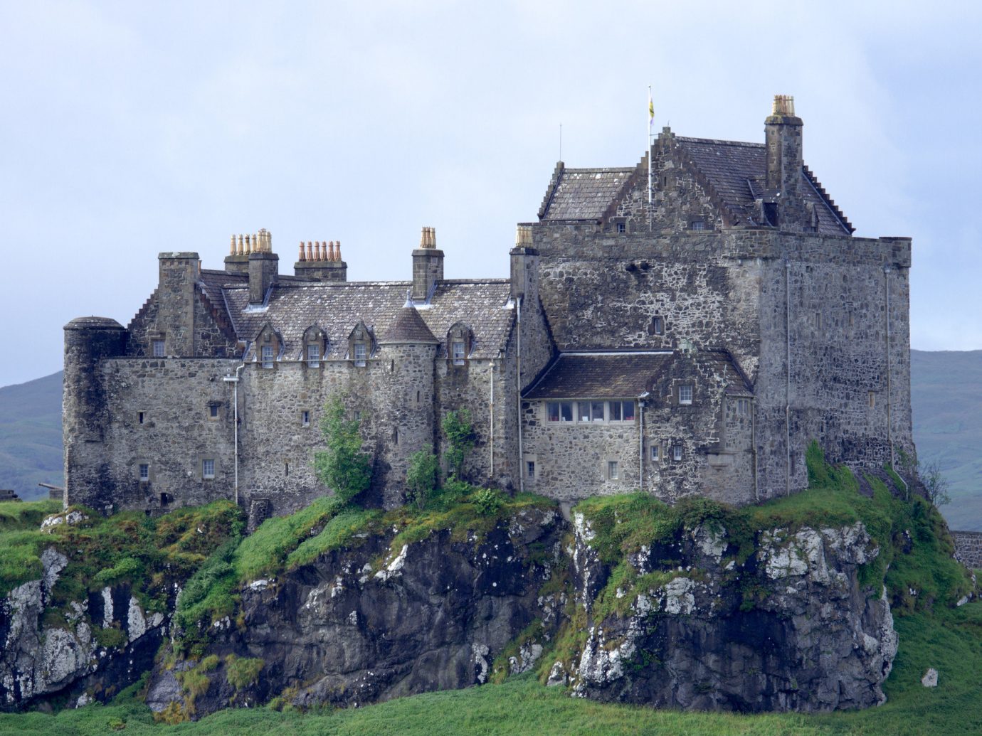 Landmarks Offbeat building grass sky outdoor castle rock château medieval architecture fortification highland stone old national trust for places of historic interest or natural beauty middle ages historic site Ruins stately home turret citadelle tours history grassy pasture hillside