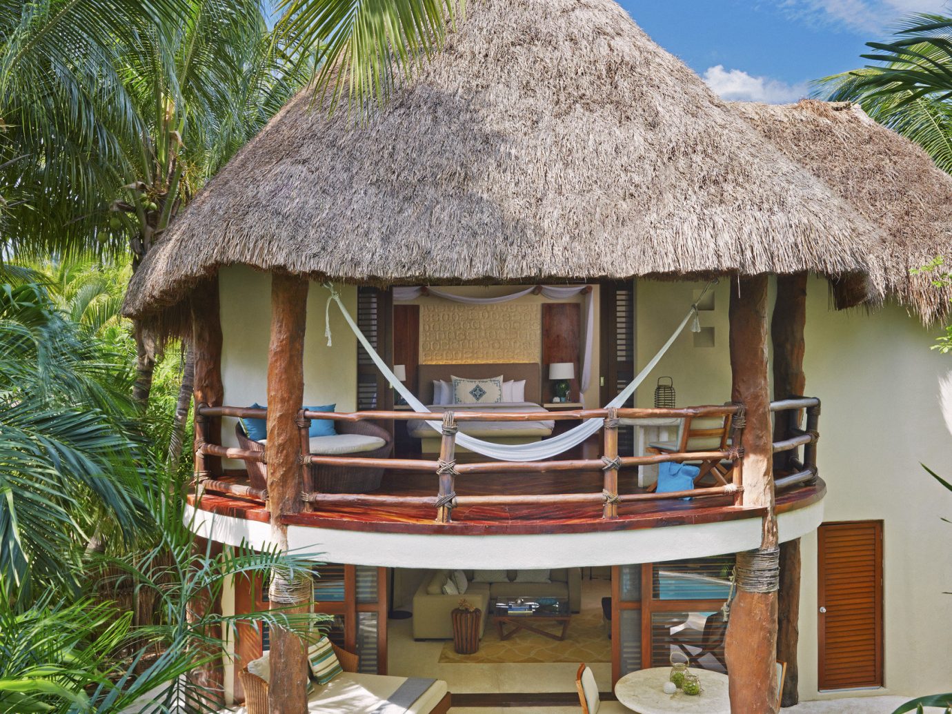 Beach Honeymoon Hotels Mexico Romance Tulum tree outdoor chair property Resort hut thatching cottage roof Jungle area furniture surrounded