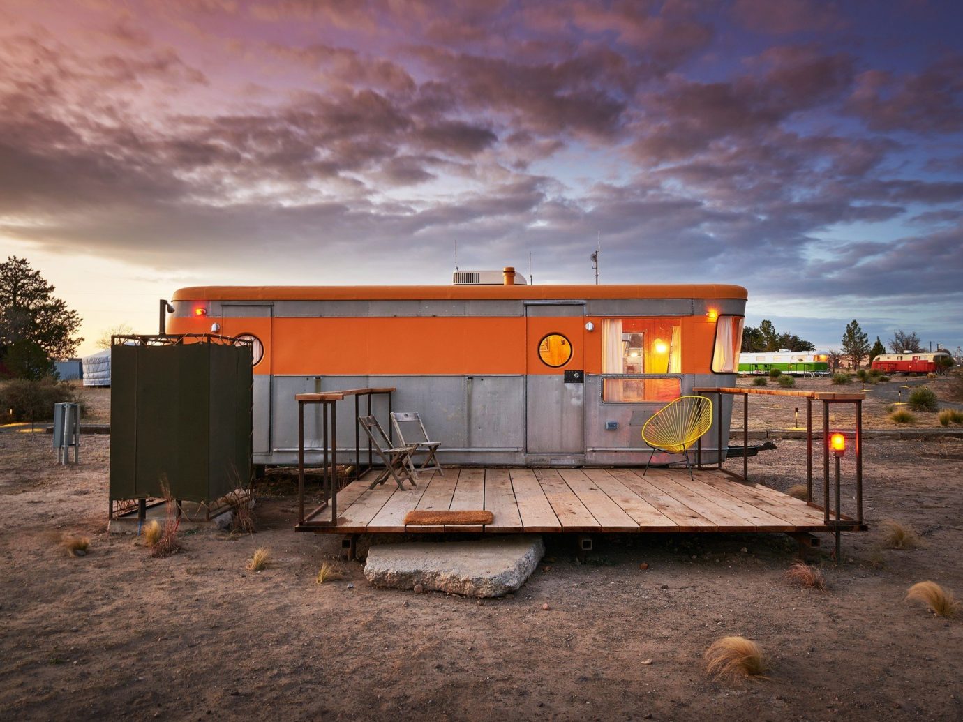 airstream ambient lighting artistic artsy calm dawn dusk Exterior Hip Hotels isolation Patio porch quirky remote serene Solo Travel Terrace trendy Trip Ideas sky ground outdoor transport orange shack cloudy