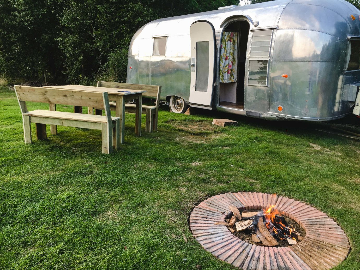Glamping Outdoors + Adventure Trip Ideas grass outdoor tree camping vehicle travel trailer trailer park caravan motor vehicle automotive exterior recreation lawn plant community