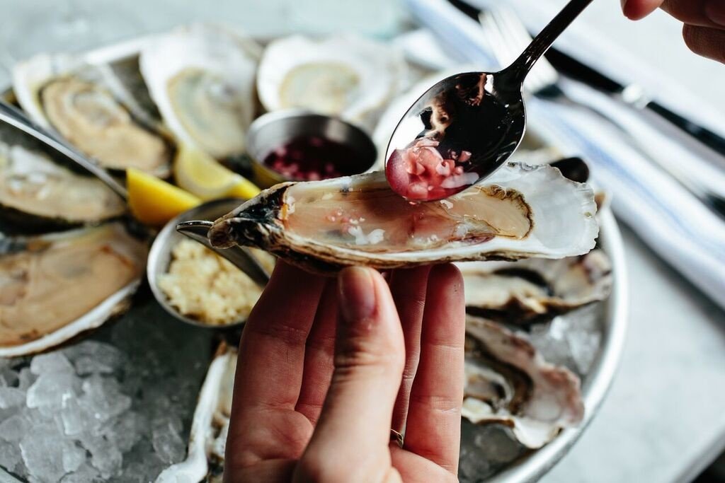 Eat food Food + Drink hand oysters Seafood plate dish meal oyster mussel fish invertebrate animal source foods clams oysters mussels and scallops produce breakfast