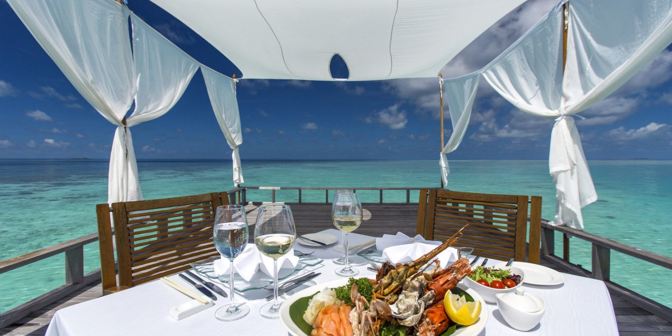 cabana calm clear water Dining Eat fine dining food Food + Drink gourmet isolation Luxury Ocean ocean view outdoor dining private private dining remote serene table setting turquoise view Boat vehicle passenger ship outdoor ship luxury yacht ecosystem yacht watercraft caribbean tent outdoor object