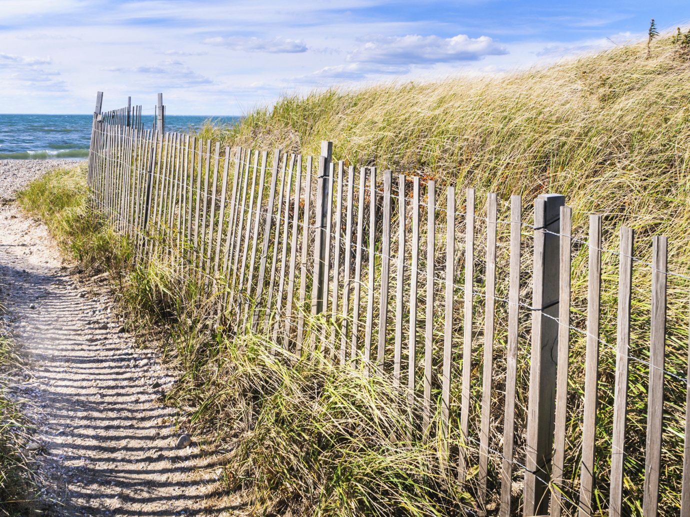Beach East Coast USA Trip Ideas Fence sky outdoor grass habitat agriculture natural environment tree ecosystem walkway grass family field wetland outdoor structure Coast home fencing shrub marsh overlooking