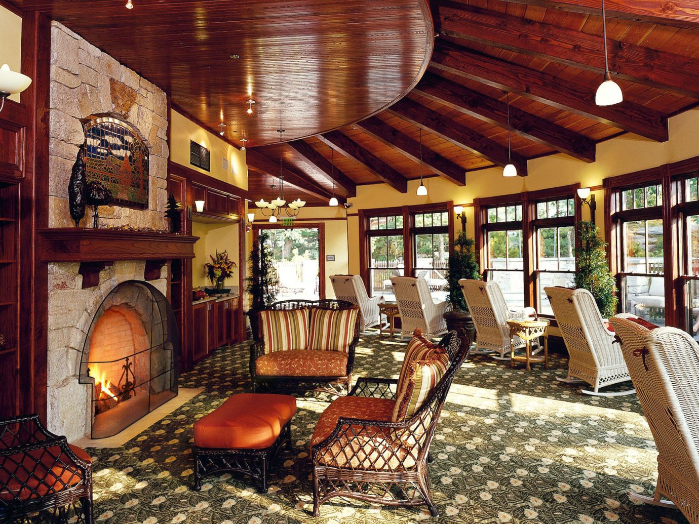 Classic Fireplace Hotels Lakes + Rivers Lounge Luxury Mountains New York Outdoor Activities Resort Romance Romantic Hotels indoor property room ceiling Living estate living room home furniture interior design log cabin cottage mansion Lobby area several