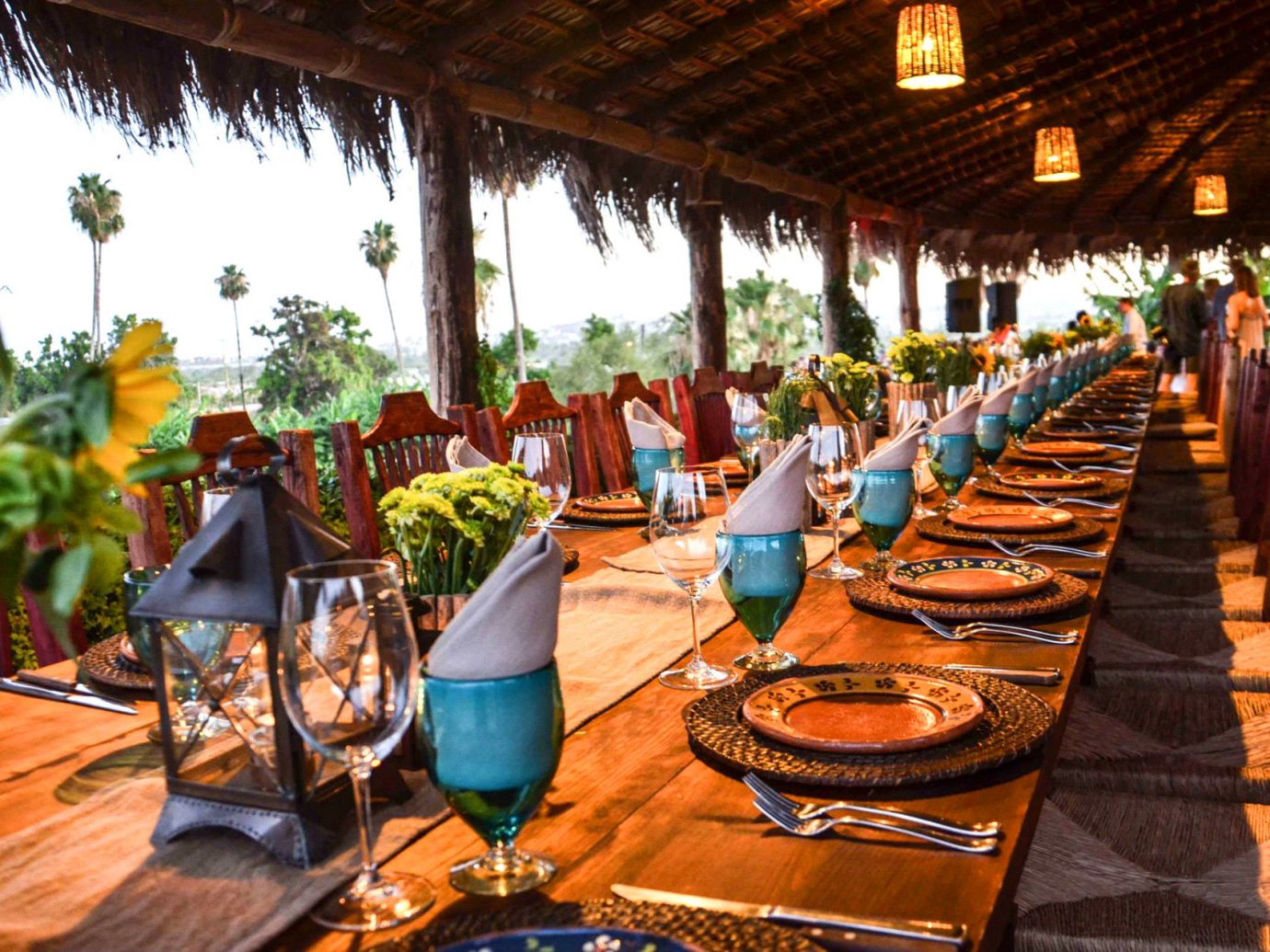 colorful Dining flowers Greenery isolation outdoor dining Outdoors private remote restaurant Rustic Scenic views table table setting thatched roof Travel Tips Trip Ideas view outdoor Resort meal tourism wooden estate wood furniture several dining table