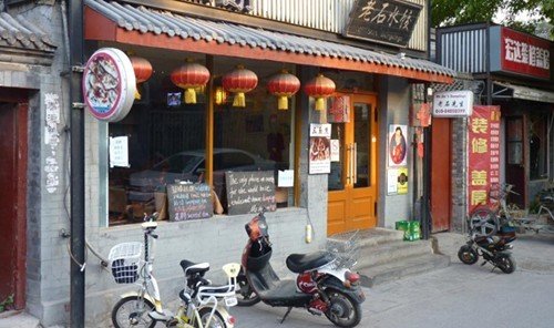 Jetsetter Guides building outdoor street road mode of transport Town sidewalk motorcycle vehicle store facade City scooter