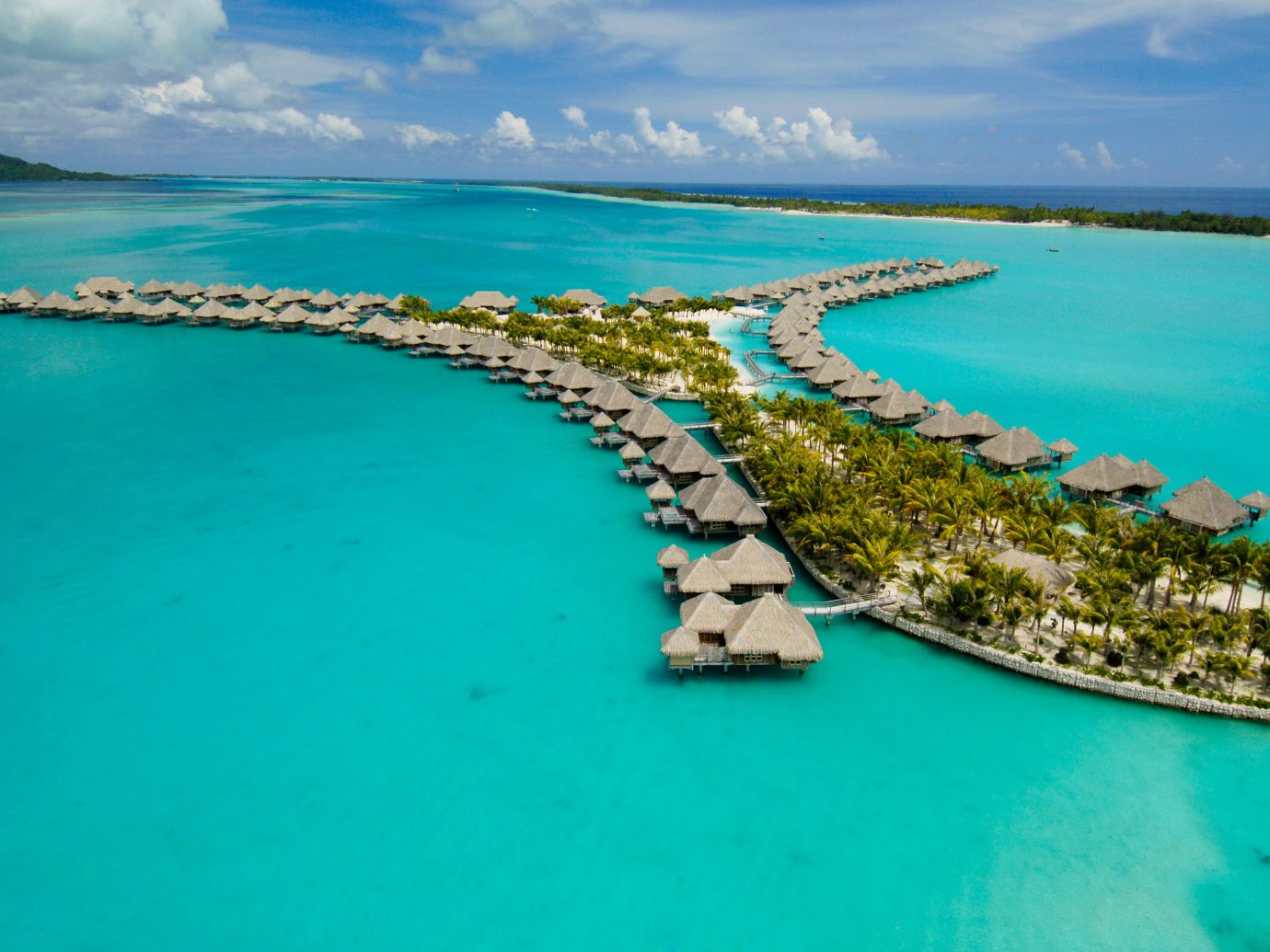 All-Inclusive Resorts Beach Boutique Hotels Hotels Island Overwater Bungalow Romance Scenic views Tropical water sky outdoor archipelago geographical feature Boat landform Ocean Sea caribbean Nature reef Coast islet bay vacation Lagoon aerial photography atoll cape inlet cay cove blue swimming shore