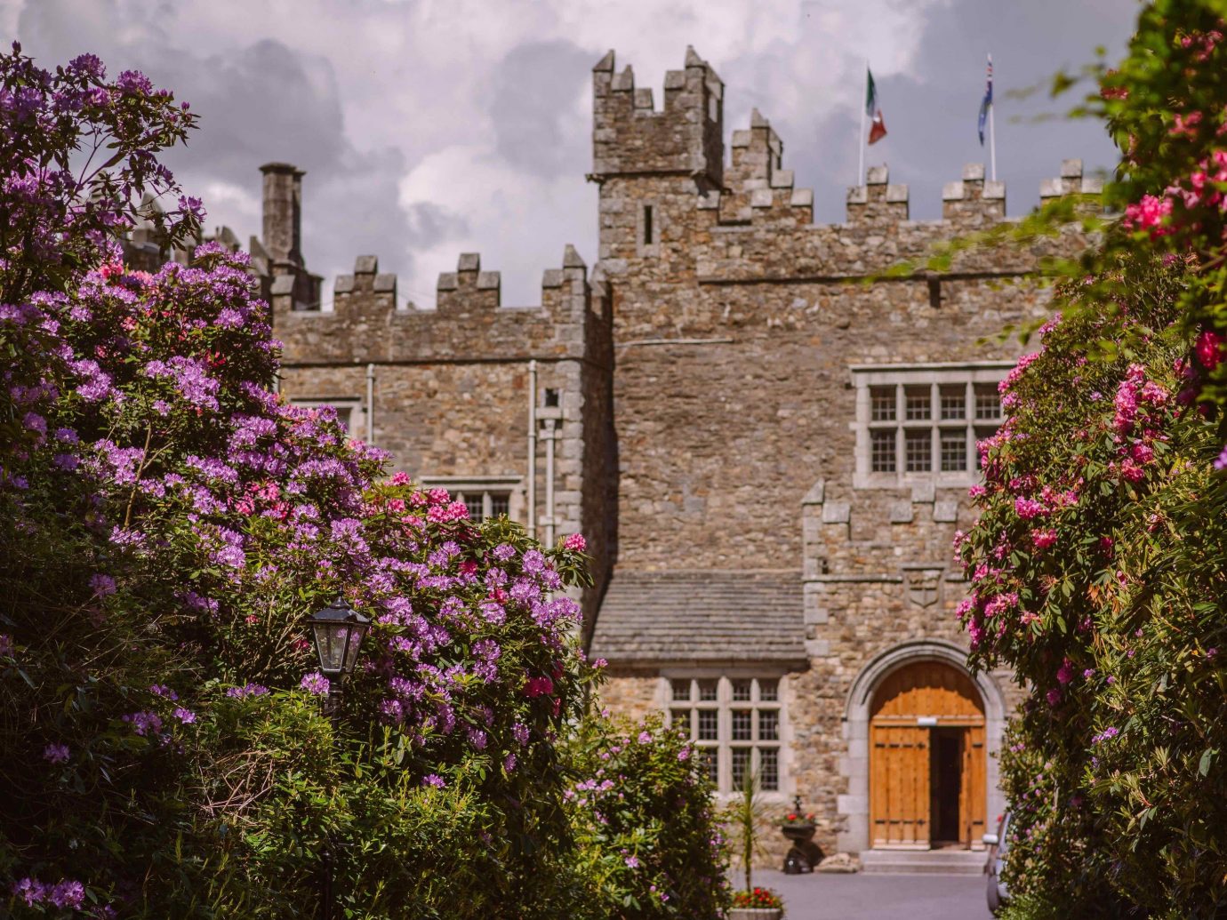 Hotels tree outdoor building sky flower City estate tourism château Garden old palace castle Courtyard stone surrounded crowd castle hotel Ireland