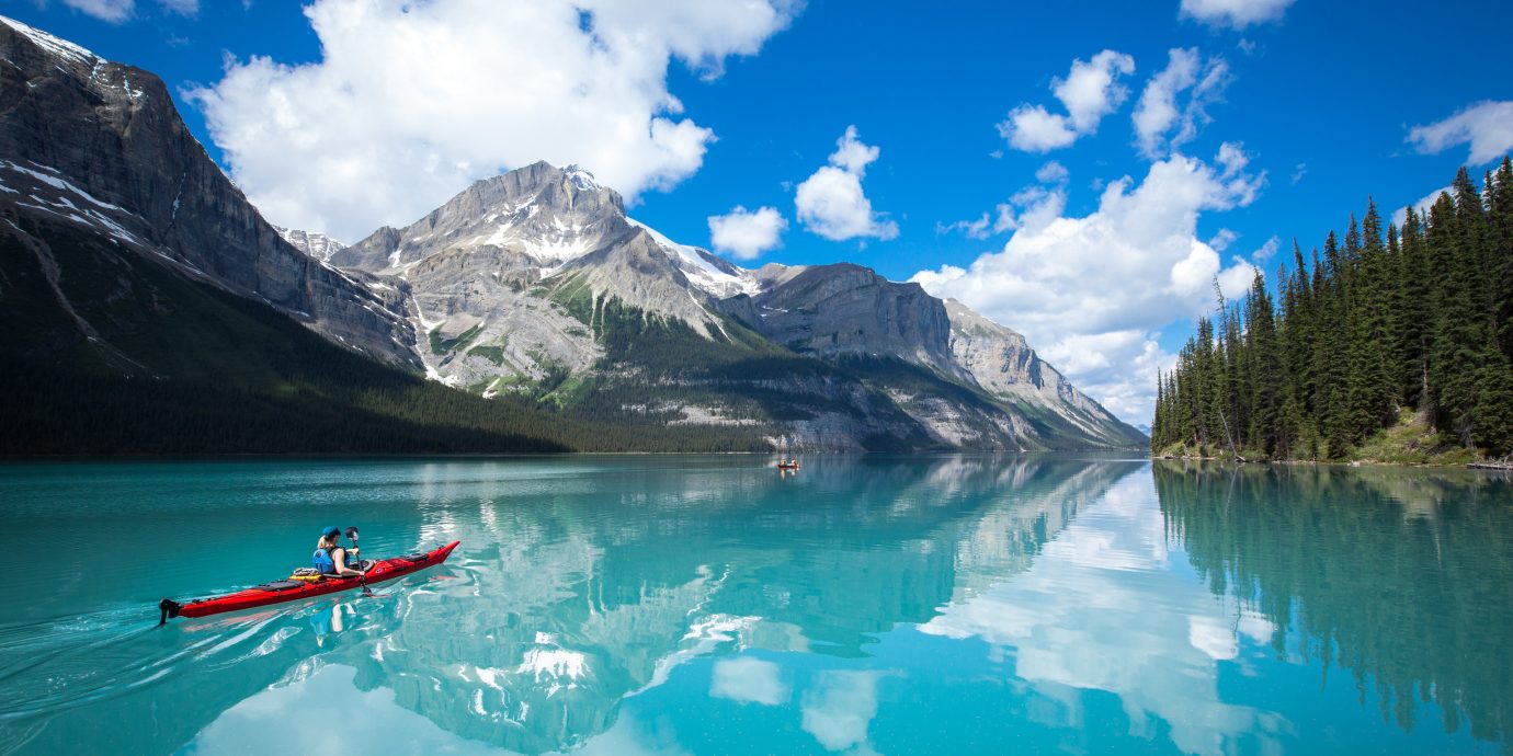 Mountains + Skiing National Parks Outdoors + Adventure Trip Ideas Weekend Getaways sky water mountain mountainous landforms outdoor Nature Lake mountain range reflection water sport fjord loch vehicle boating alps glacial landform swimming