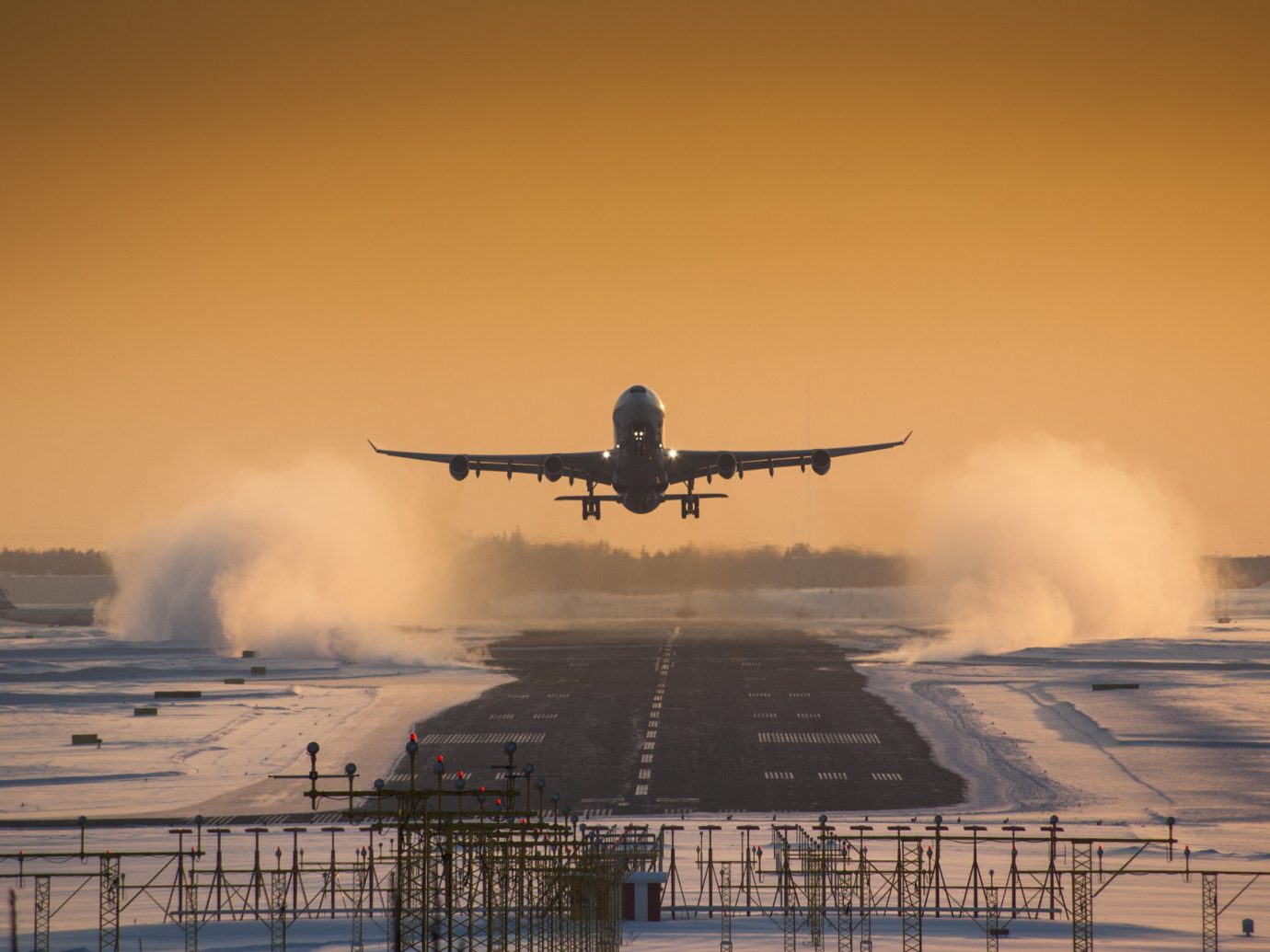 aerial airplane airport flying landing road snow Sunset transportation Travel Tips Winter outdoor sky plane smoke atmospheric phenomenon airline coming aviation aircraft atmosphere of earth airliner vehicle morning flight air force sunrise takeoff wing runway engine