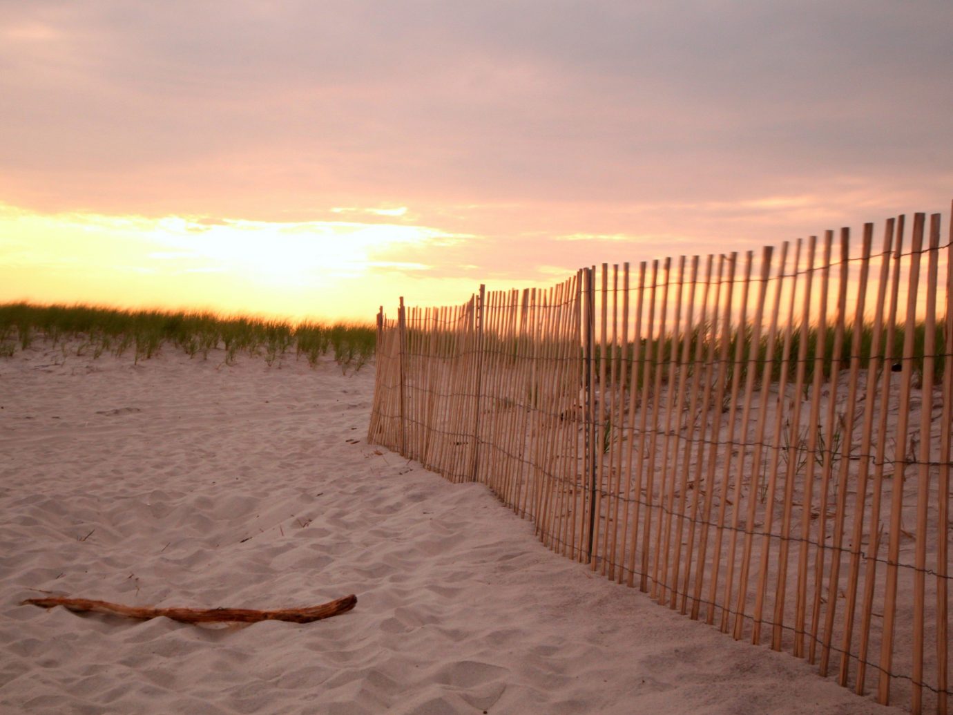 Trip Ideas sky outdoor Sunset morning Beach sunlight Sea wood walkway sand Fence outdoor structure sunrise