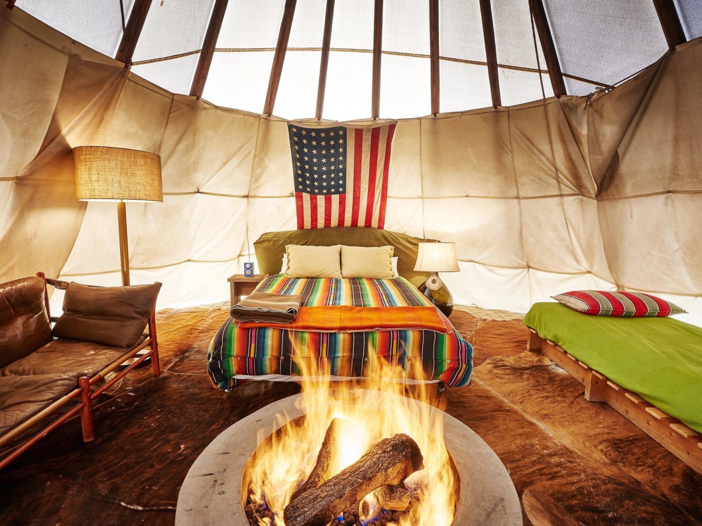 artistic artsy bed Bedroom cozy fire Firepit Fireplace Hip Hotels interior isolation living area quirky remote Solo Travel teepee trendy Trip Ideas indoor decorated bedclothes furniture