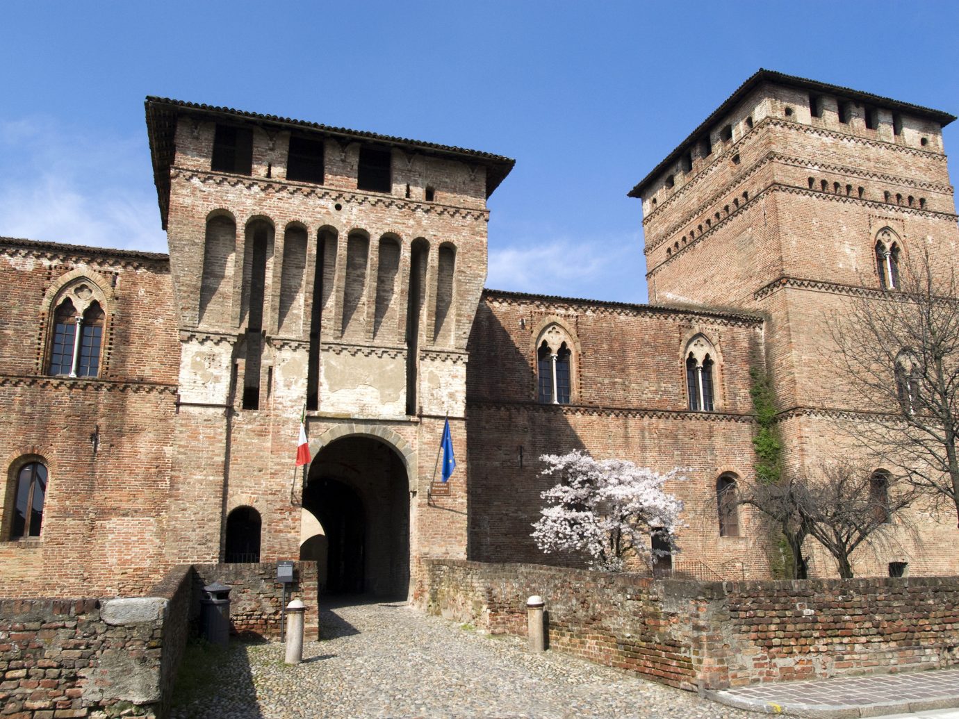 Arts + Culture Italy Milan Trip Ideas historic site medieval architecture building wall history fortification arch sky ancient history castle facade middle ages palace château