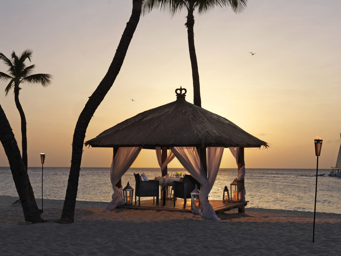 Beach Beachfront Hotels Living Lounge Luxury Ocean sky water outdoor chair Sea shore Sunset vacation morning evening tree Nature palm dusk sand travel sailing vessel shade sandy day