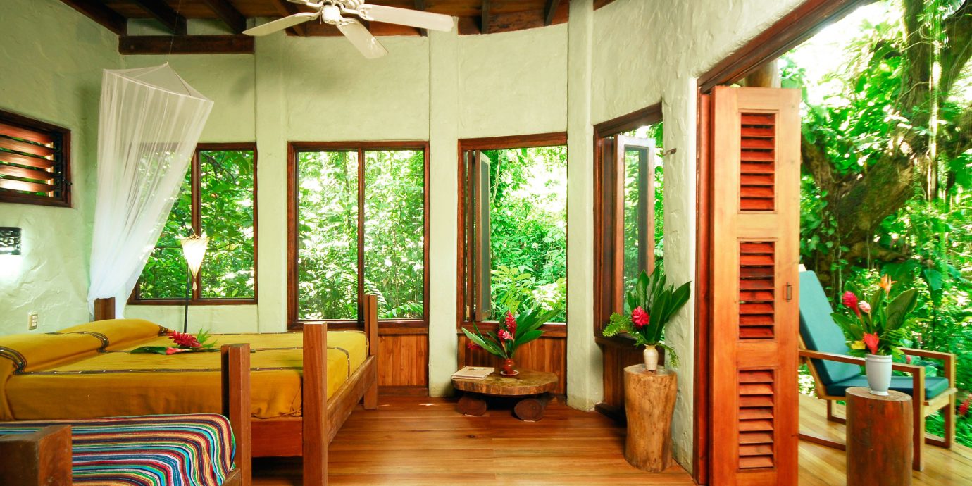 Adventure All-inclusive Balcony Bedroom Eco Honeymoon Jungle Outdoor Activities Outdoors Romantic Rustic Scenic views Suite property house porch Resort home cottage log cabin living room Villa outdoor structure farmhouse hard