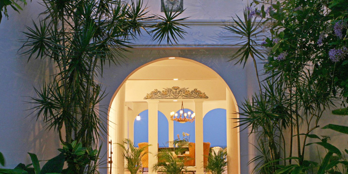 Luxury Resort tree plant building property house Courtyard home Architecture arch hacienda Villa mansion palm bushes Garden altar colonnade