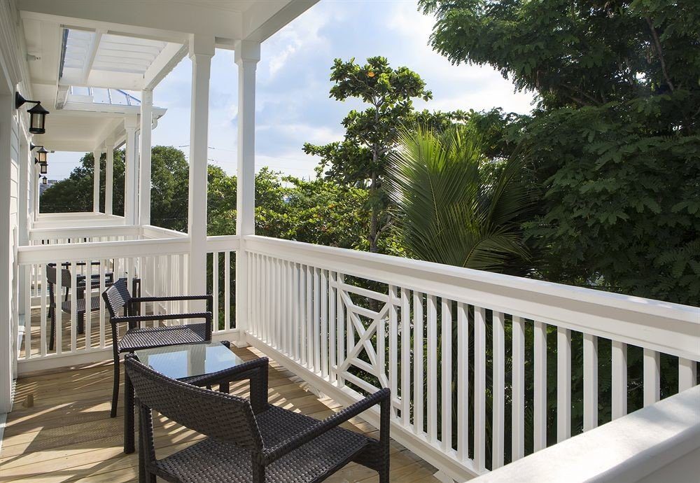 tree building porch chair property white house home Deck outdoor structure cottage Villa backyard Balcony condominium