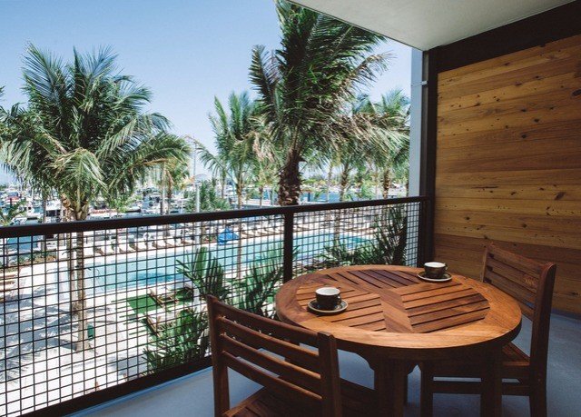 property Resort Balcony condominium palm tree arecales swimming pool penthouse apartment Villa hacienda dining table
