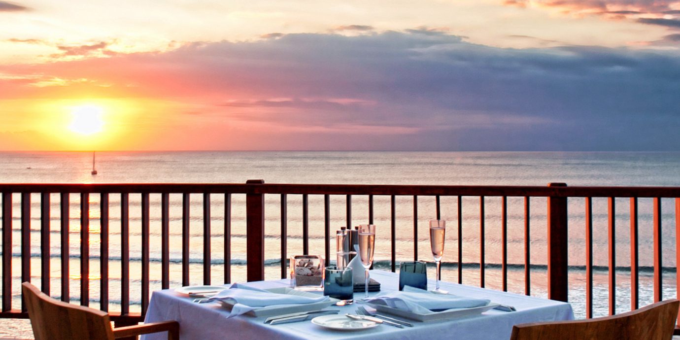 Bar Beachfront Dining Drink Eat Nightlife Scenic views sky chair water property Ocean overlooking Resort set dining table