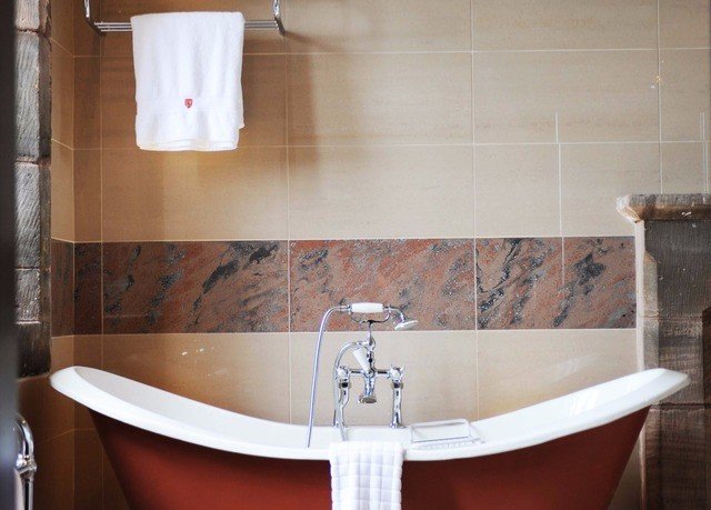 bathroom plumbing fixture bathtub sink bidet flooring tub Bath toilet tiled tile water basin