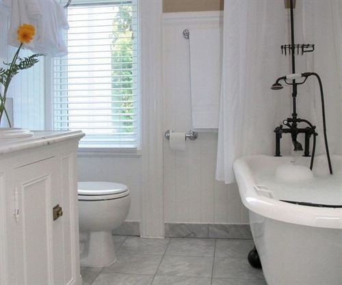 bathroom property white toilet plumbing fixture bidet sink cottage tub tile tiled bathtub Bath