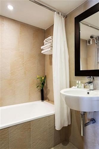 bathroom sink mirror property tub plumbing fixture bathtub tile Bath tiled
