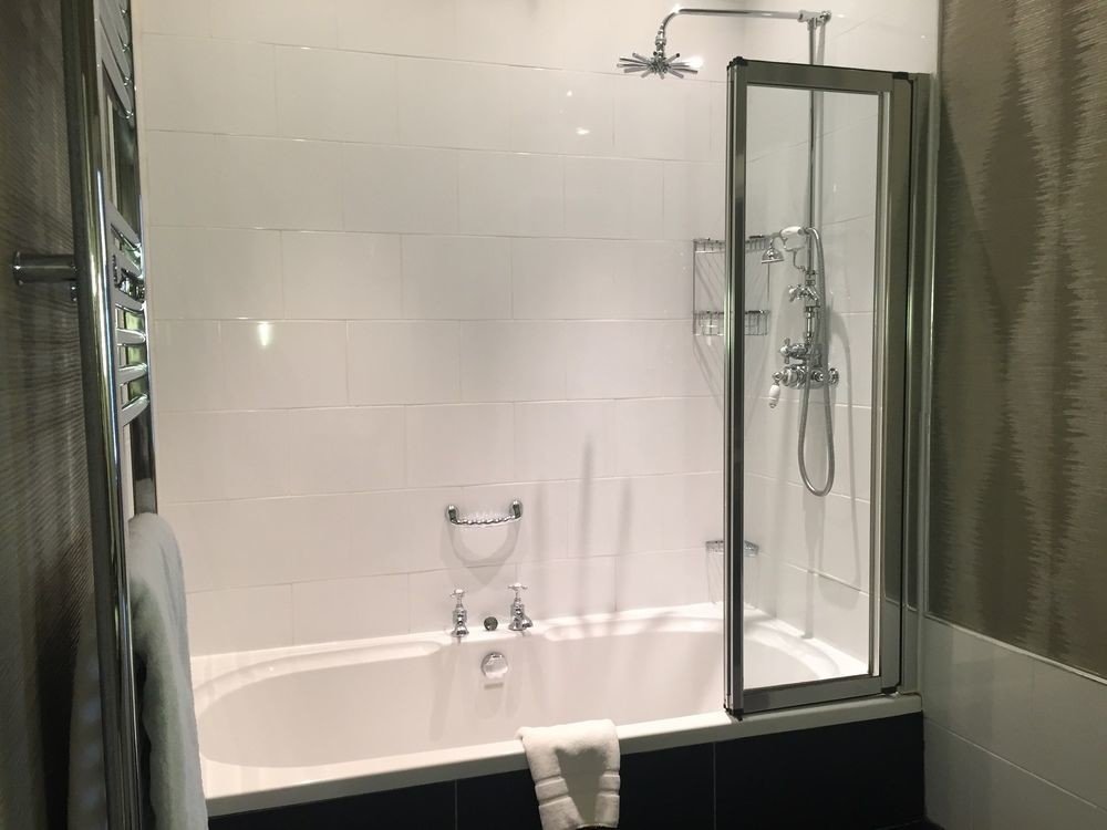 bathroom shower toilet scene plumbing fixture white sink bathtub Bath tiled