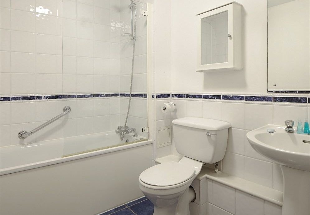 bathroom sink property toilet bidet plumbing fixture flooring tub Bath tiled