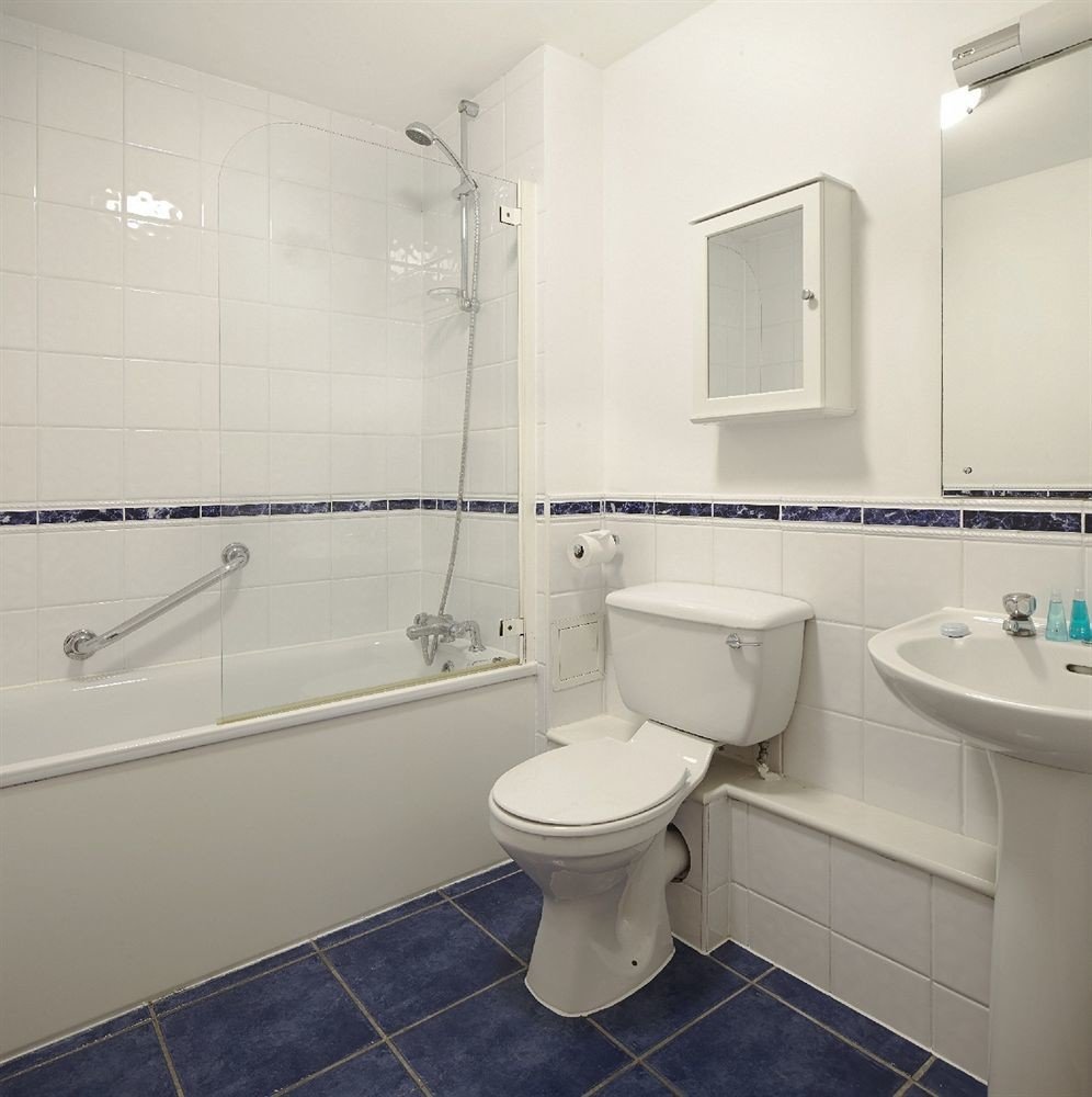 bathroom sink property toilet bidet plumbing fixture flooring tub Bath tiled