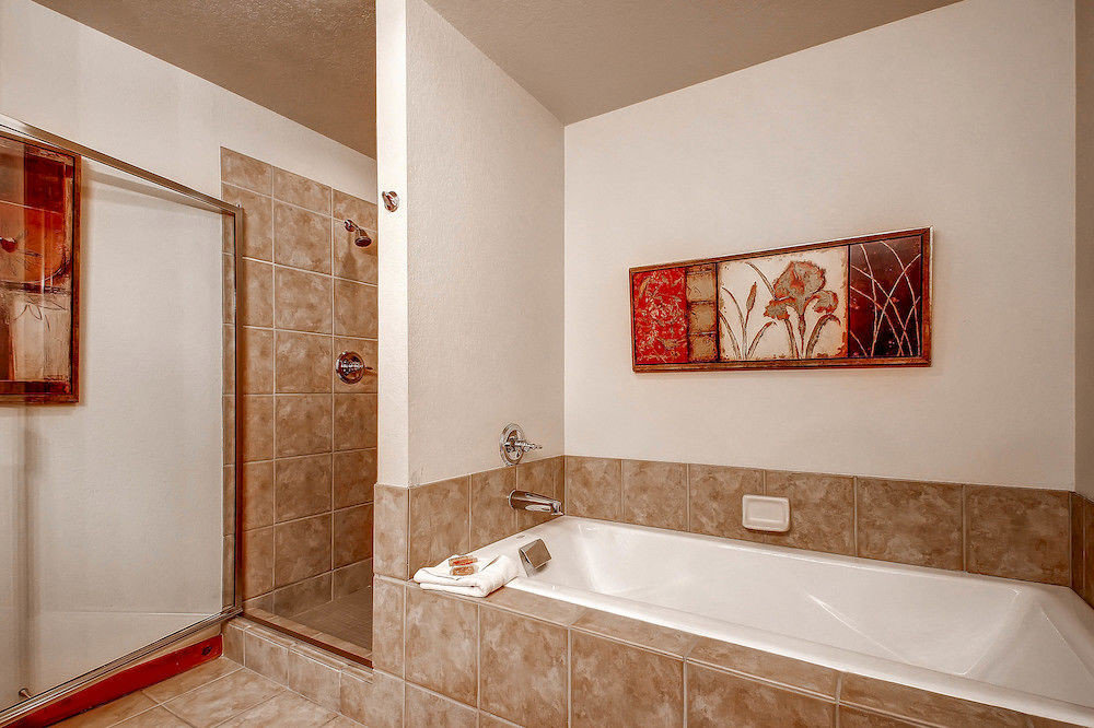 Bath Classic Resort bathroom property mirror sink vessel home flooring plumbing fixture bathtub tile tiled tan