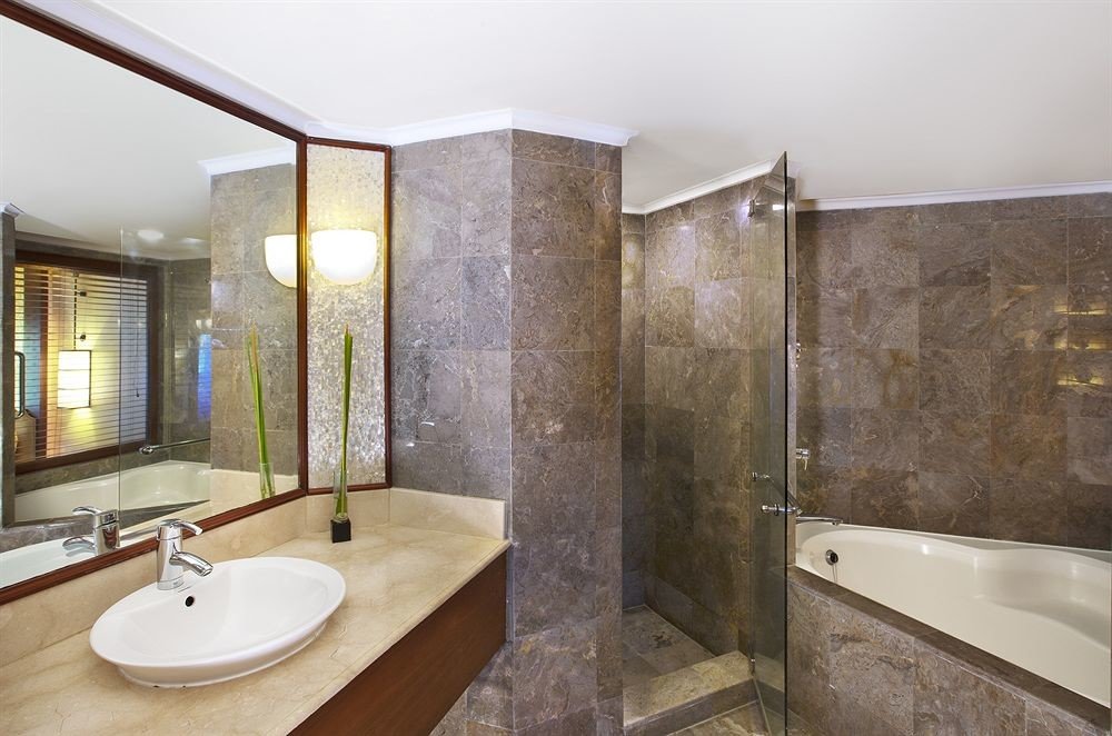 bathroom property sink bathtub shower home plumbing fixture Suite flooring toilet tan tub tile tiled Modern Bath