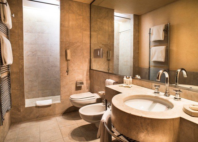 bathroom sink toilet property Suite plumbing fixture tub tile Bath tiled bathtub tan