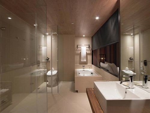bathroom property sink toilet lighting flooring Suite tub bathtub tile Bath tiled