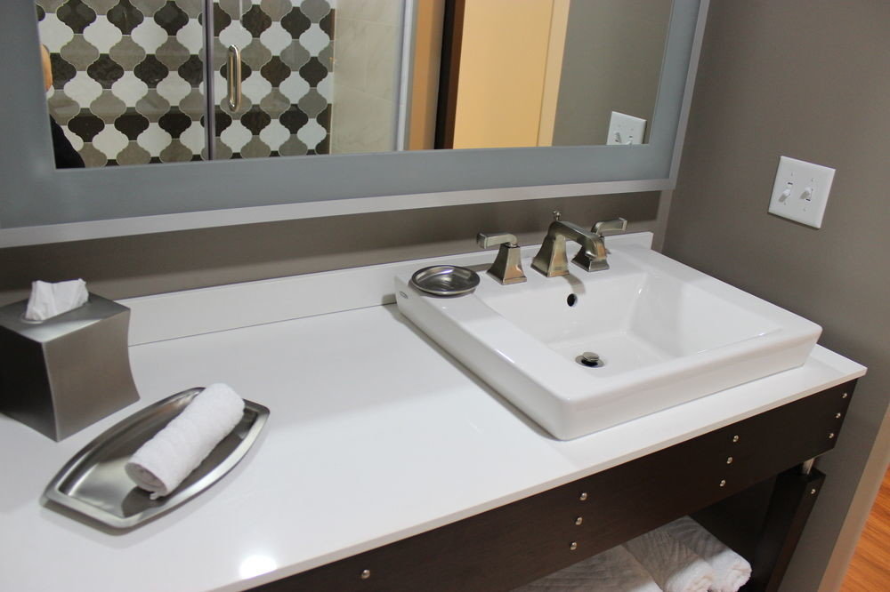 bathroom sink mirror property plumbing fixture countertop bidet bathtub flooring