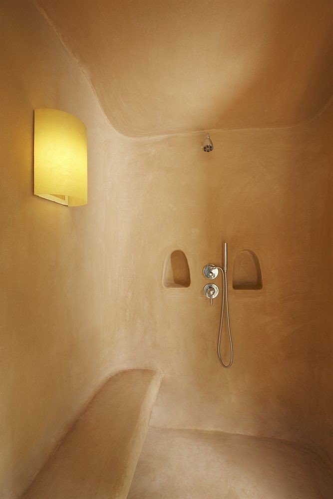 bathroom plumbing fixture lighting bathtub bidet plaster toilet tan