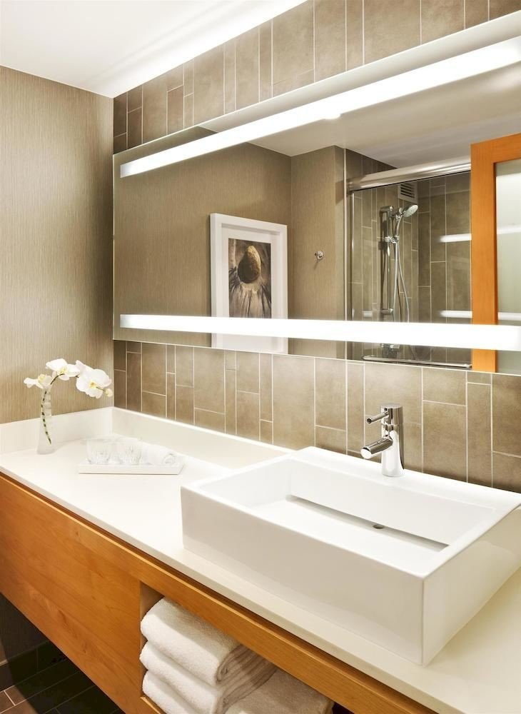 bathroom mirror sink plumbing fixture cabinetry countertop bathtub home flooring