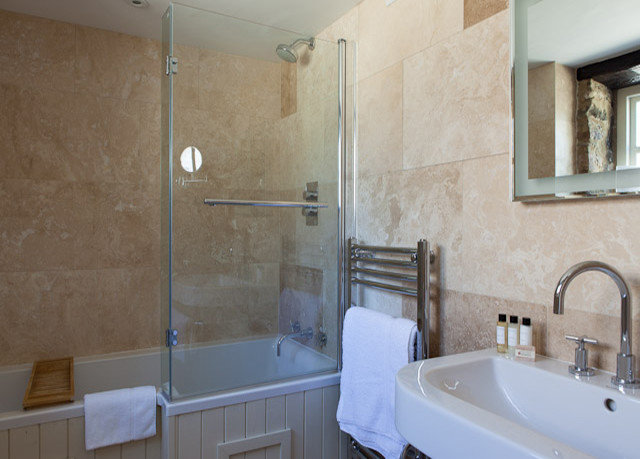 bathroom property sink toilet plumbing fixture white home bathtub tan tub tile tiled