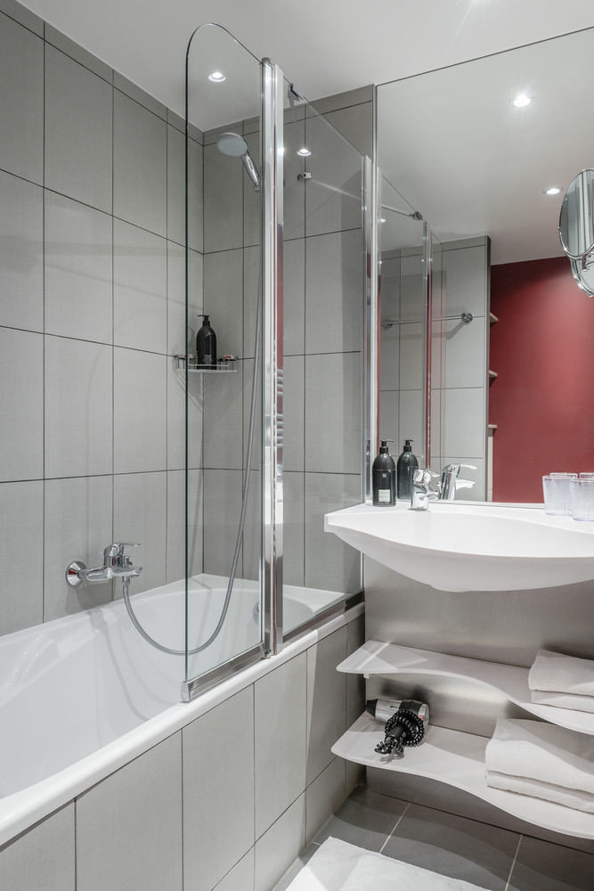 bathroom sink plumbing fixture toilet white vessel bathtub tiled tile