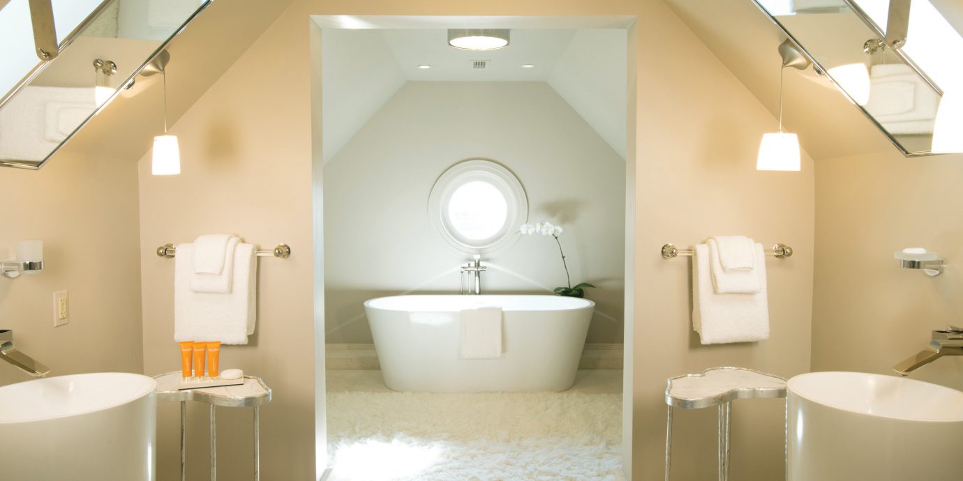 bathroom mirror property toilet sink towel home plumbing fixture rack tan tub