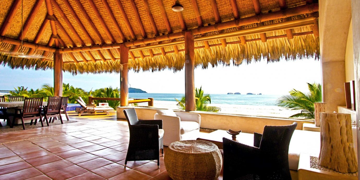 Beach Beachfront Deck Scenic views chair Resort property Villa hacienda eco hotel restaurant