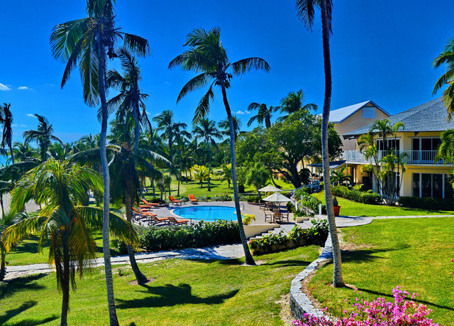 tree grass sky palm leisure Resort plant arecales tropics caribbean lawn Beach swimming pool lined