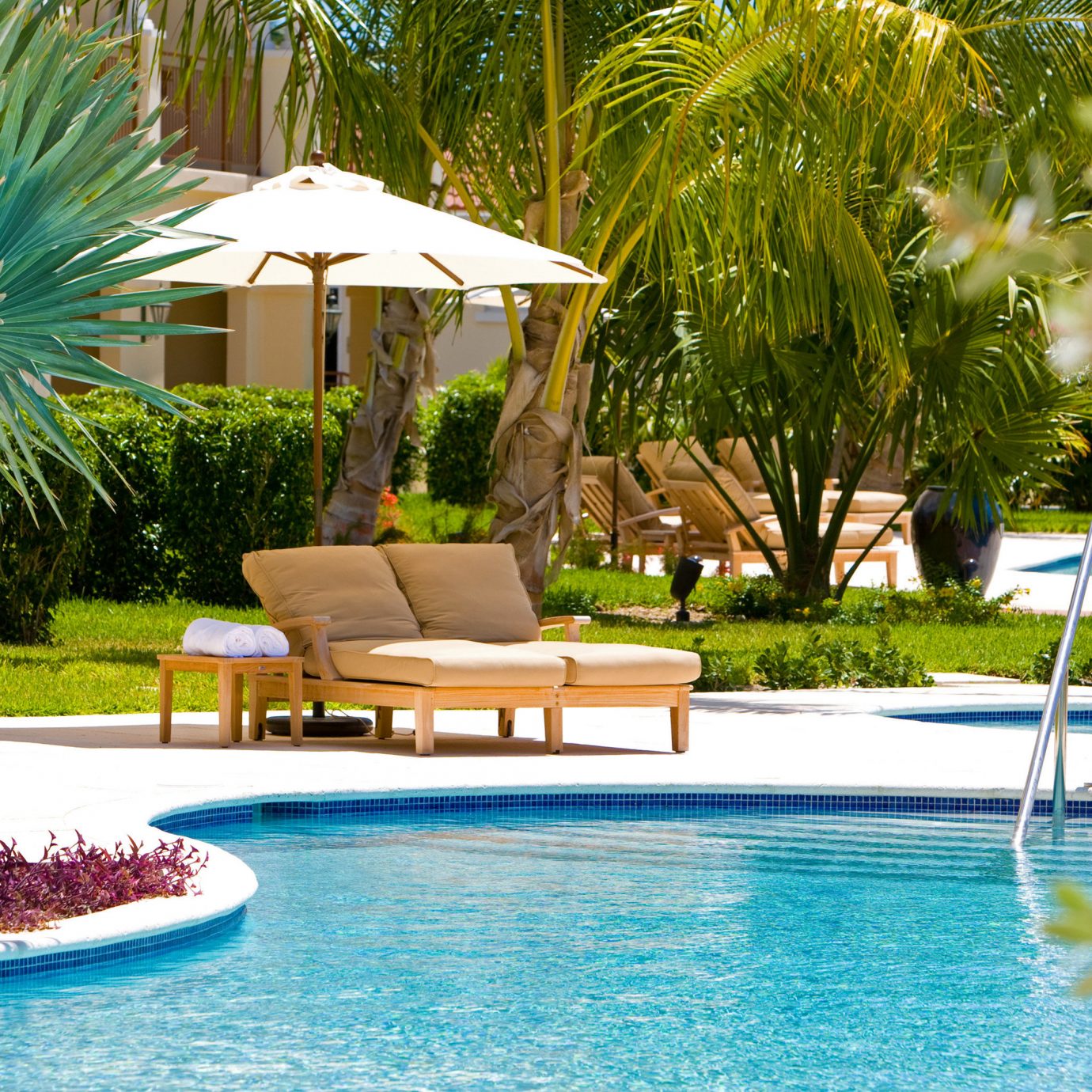 Beachfront Grounds Play Pool tree Resort swimming pool leisure property backyard Villa home condominium swimming palm