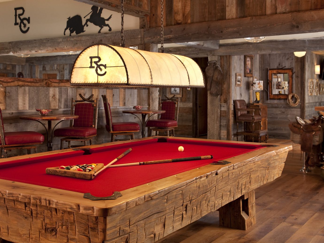Glamping Hotels Montana Outdoors + Adventure Trip Ideas indoor billiard room recreation room floor room wooden billiard table furniture games wood estate table indoor games and sports cue sports